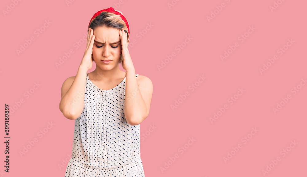 Young beautiful blonde woman wearing casual clothes suffering from headache desperate and stressed because pain and migraine. hands on head. Young beautiful blonde woman wearing casual clothes suffering from headache desperate and stressed because pain and migraine. hands on head.