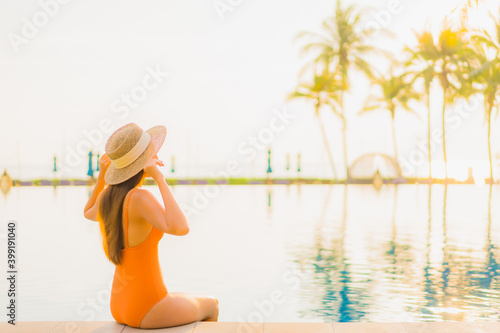 Portrait beautiful young asian woman relax smile leisure around outdoor swimming pool nearly sea beach ocean