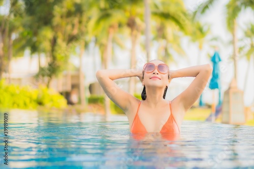 Portrait beautiful young asian woman relax smile leisure around outdoor swimming pool nearly sea beach ocean © siraphol