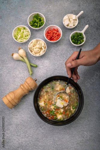 girl preparing vegetable soup with ingredients