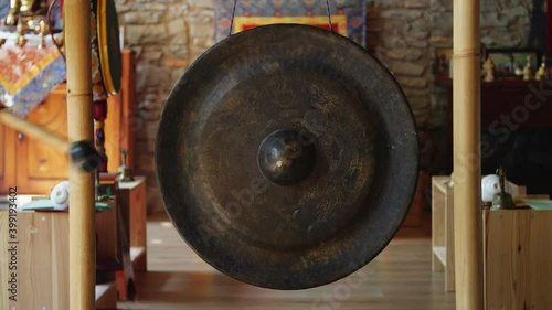 Asian religious metal gong sounded to alert monks of prayer time - religion, tradition and lifestyle concept