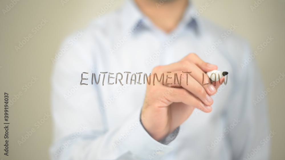 Entertainment Law, man writing on transparent screen Entertainment Law, man writing on transparent screen
