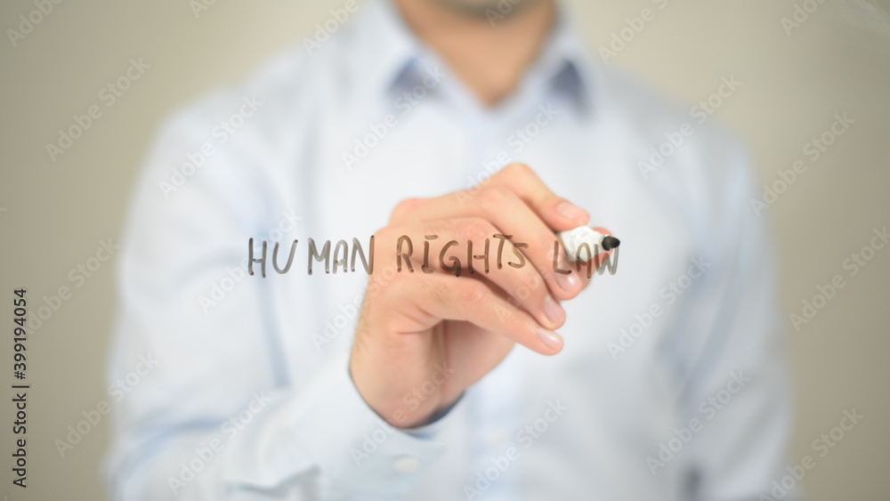 Human Rights Law, man writing on transparent screen Human Rights Law, man writing on transparent screen