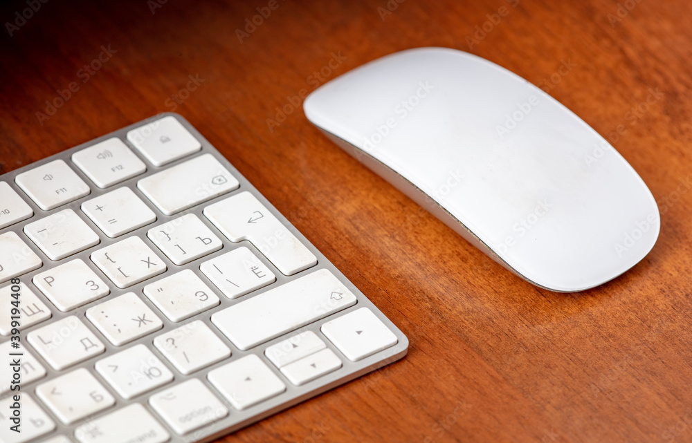 White keyboard and computer mouse on the table. White keyboard and computer mouse on the table.