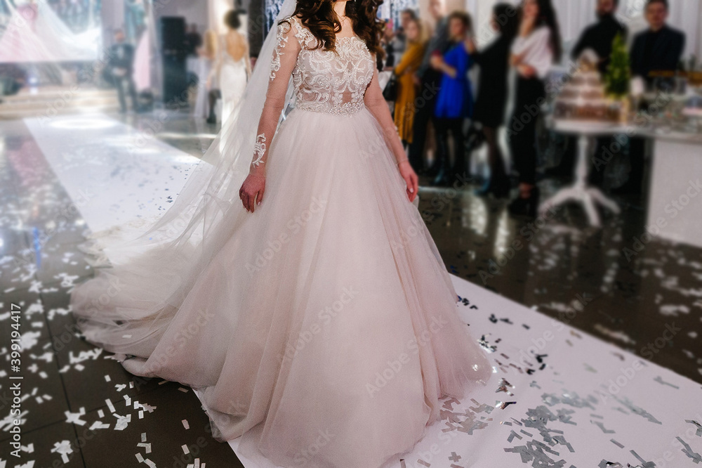 Fototapeta premium Bride at ceremony in wedding day. Woman in an expensive, luxury dress, details of models walking on the collection catwalk during the Bridal Week runway.