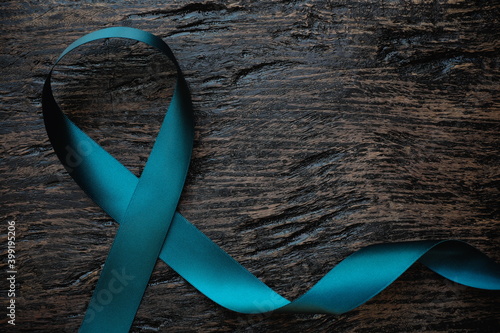 Obraz na plátně Top view of  teal ribbon on dark background with copy space