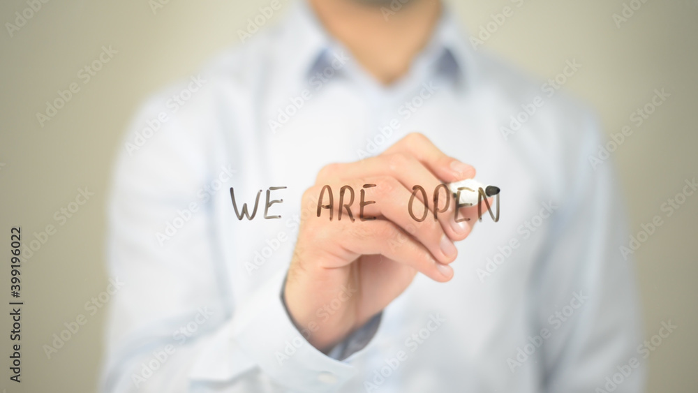 We Are Open, man writing on transparent screen We Are Open, man writing on transparent screen