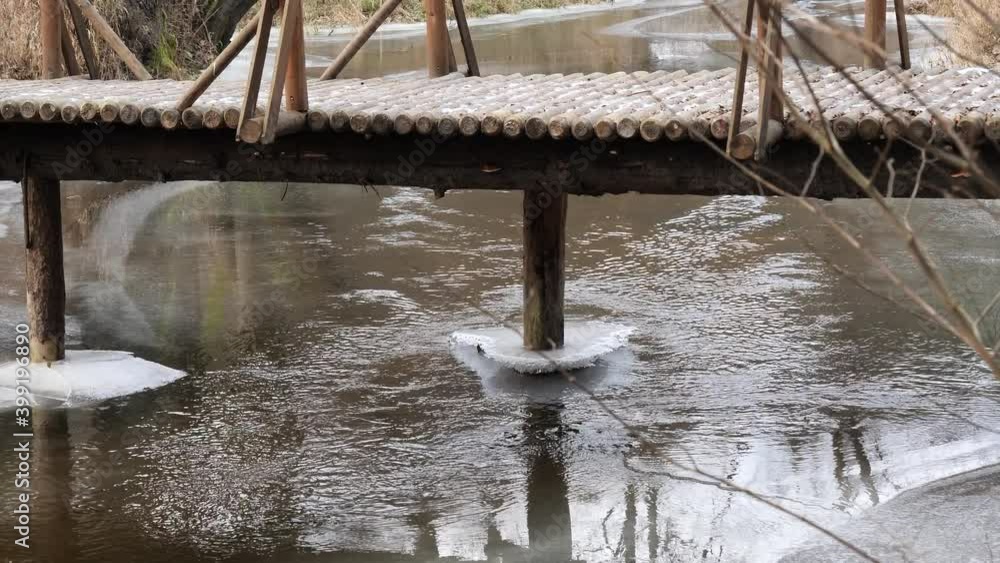 the bridge over the winding forest river the first ice on the water the bridge over the winding forest river the first ice on the water