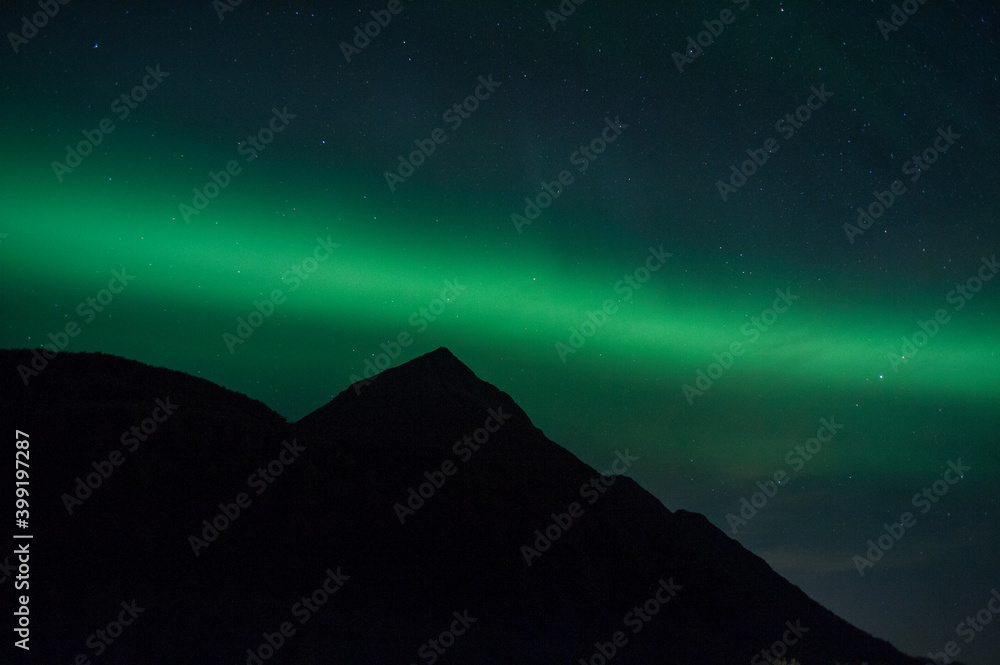 Aurora band over a Alaskan mountain.