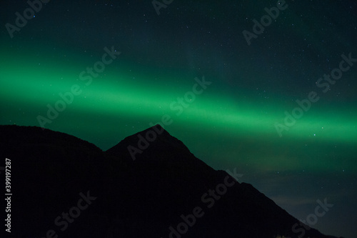 Aurora band over a Alaskan mountain.