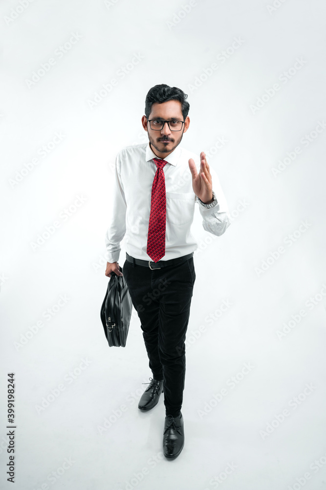Young indian business man stepping up for success over a white background Young indian business man stepping up for success over a white background