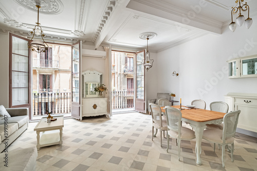 Beautiful bright interior. Classic room with tile floor, light walls, balconies and vintage elements of decoration.