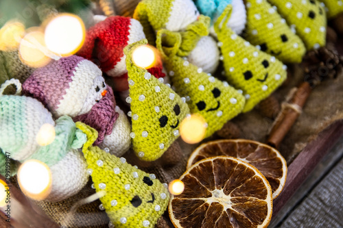 A set of handmade Christmas tree toys crocheted in a wooden tray with burlap. Country style.