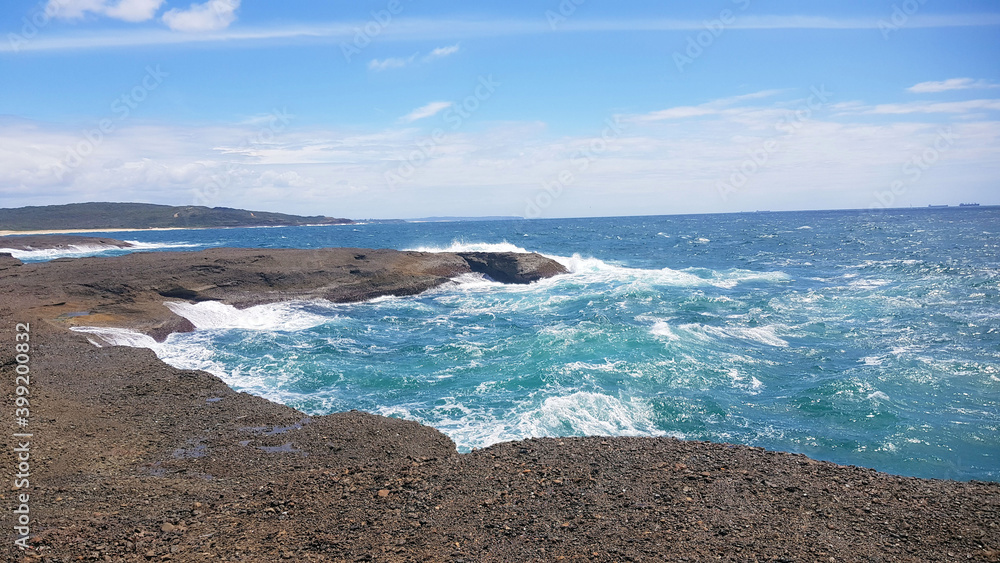 The Rock Platform at Moonee Beach Near Catherine Hill Bay New South Wales Australia, with Ocean Waves crashing over the rocks The Rock Platform at Moonee Beach Near Catherine Hill Bay New South Wales Australia, with Ocean Waves crashing over the rocks