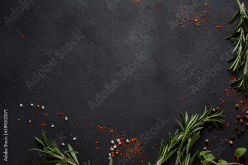 Spices and herbs on dark stone background