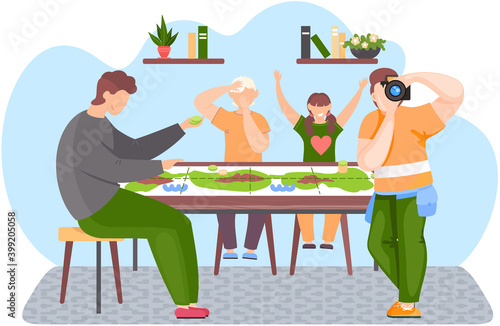 People sitting at a table and playing a board game. Guy is standing and adjusting the lens. Children joyfully raise their hands up. Family pastime at home. Man is sitting with green chips in his hands