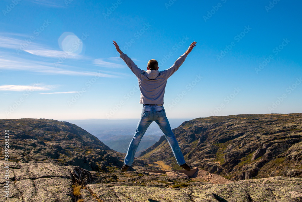 Happy Man jumping at mountains to clouds sky Lifestyle Travel emotional euphoria success concept adventure active vacations outdoor Happy Man jumping at mountains to clouds sky Lifestyle Travel emotional euphoria success concept adventure active vacations outdoor