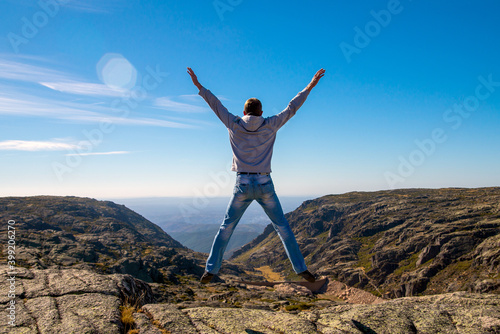 Obraz na płótnie Happy Man jumping at mountains to clouds sky Lifestyle Travel emotional euphoria success concept adventure active vacations outdoor w salonie