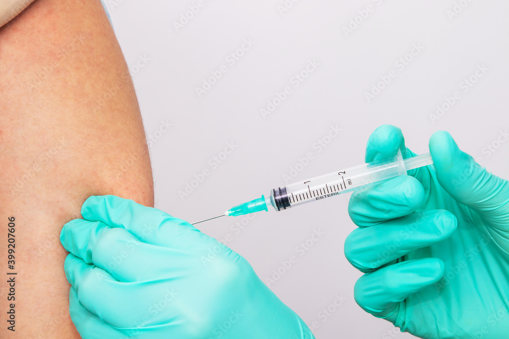 hands of doctor or nurse putting vaccine on arm hands of doctor or nurse putting vaccine on arm