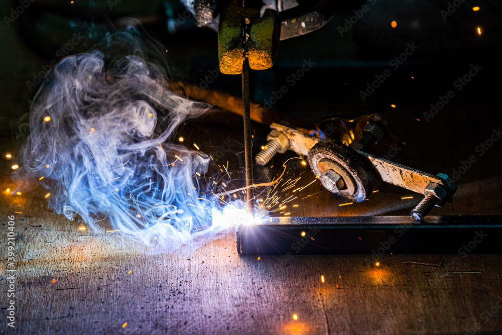 Professional welder man working on metal welding and sparks metal.
Professional welder man working on metal welding and sparks metal.