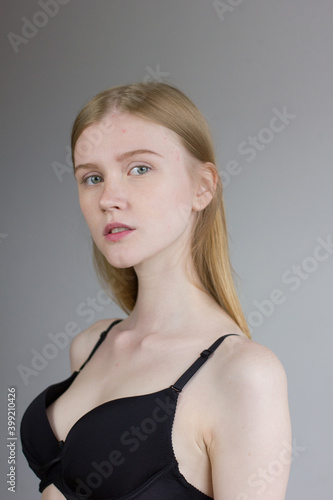 Young woman in black underwear standing over white studio background. Snap, set.
