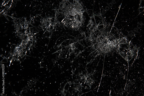 cracks on black glass background, broken abstract glass hole destruction concept