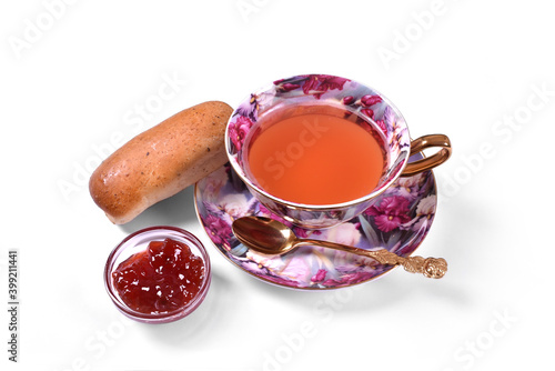 Cup of tea with golden spoon pastry and jam breakfast on white background