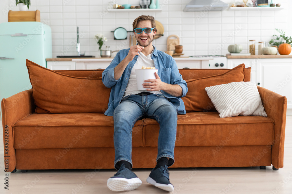 Young man with popcorn in hands watching tv at home. Young man with popcorn in hands watching tv at home.