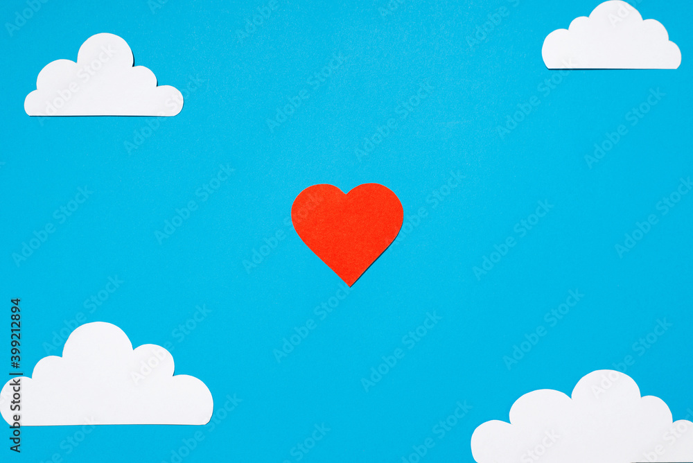 Red heart and white clouds cut from paper, blue background. Flat lay, top view. Love concept, valentine's day, greeting card. Red heart and white clouds cut from paper, blue background. Flat lay, top view. Love concept, valentine's day, greeting card.