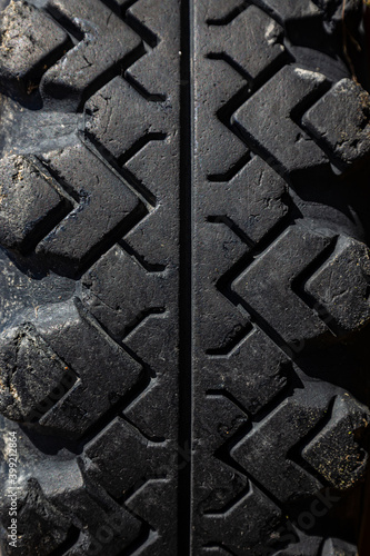 Close up of a protector of an automobile tire cover, tire tread cover pattern, texture of rubber on wheels, macro background volume black