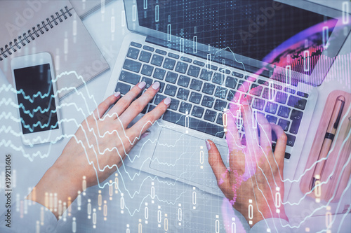 Double exposure of woman hands working on computer and forex graph hologram drawing. Top View. Financial analysis concept. © peshkova