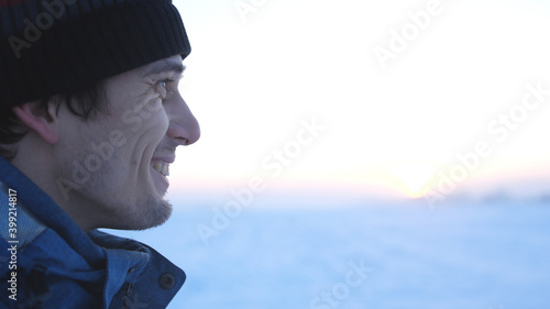 Face at profile of unshaved happy handsome smiling man in winter © emaria