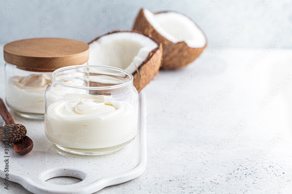 Vegan coconut yogurt in glass jars, white background. Vegan food concept. Vegan coconut yogurt in glass jars, white background. Vegan food concept.