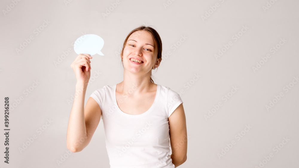 Young woman holding a speech bubble Young woman holding a speech bubble