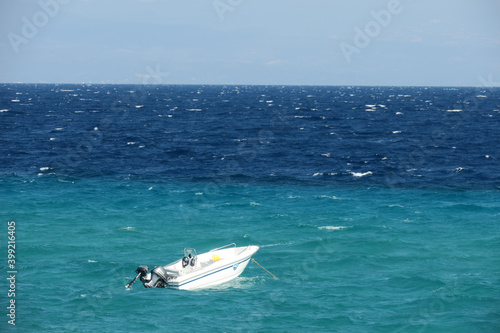 boat at anchor in a choppy sea © lenus-ss