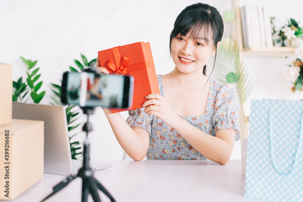 Young Asian woman live stream to give gifts to the audience watching her stream on social networking platforms Young Asian woman live stream to give gifts to the audience watching her stream on social networking platforms