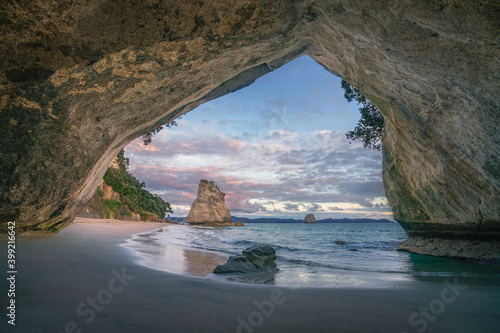 view from the cave at cathedral cove beach at sunrise,coromandel,new zealand