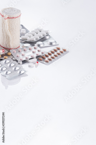 pills and band on white background photo