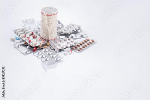 pills and band on white background photo