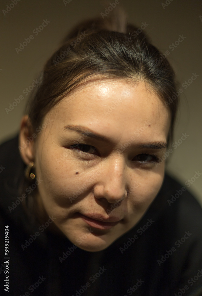 beautiful girl posing in front of the camera on a dark background beautiful girl posing in front of the camera on a dark background