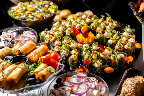 Beautifully decorated catering banquet table with different food snacks and appetizers with sandwich