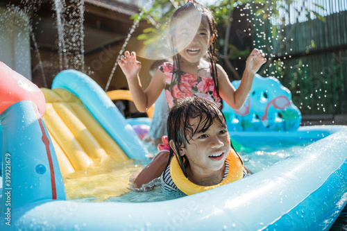 Portrait of children very happy playing water together on the playground photo