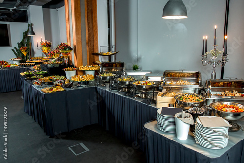 Beautifully decorated catering banquet table with different food snacks and appetizers with sandwich