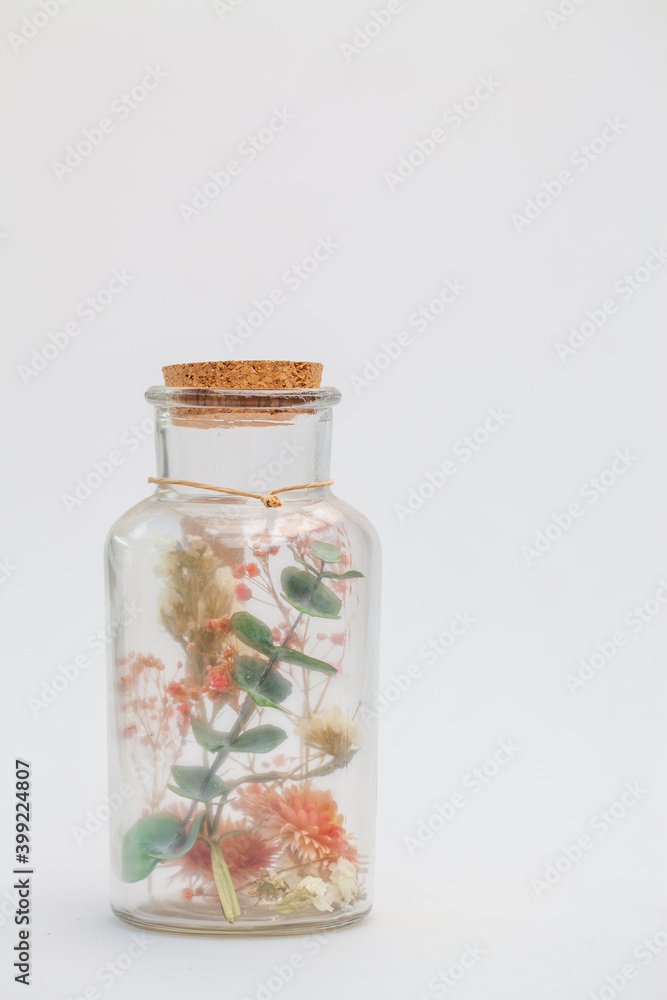 bouquet of dry flowers and potpourri in a glass jar on a white table. High quality photo bouquet of dry flowers and potpourri in a glass jar on a white table. High quality photo