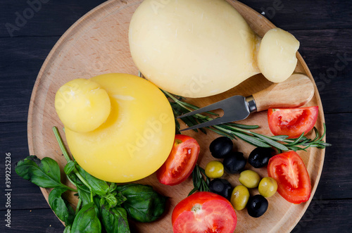 Traditional italian cheese Caciocavallo, homemade cheesy Pasta filata with vegetables photo