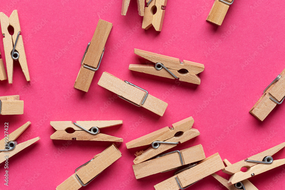 Many wooden clothespin on pink background. Many wooden clothespin on pink background.