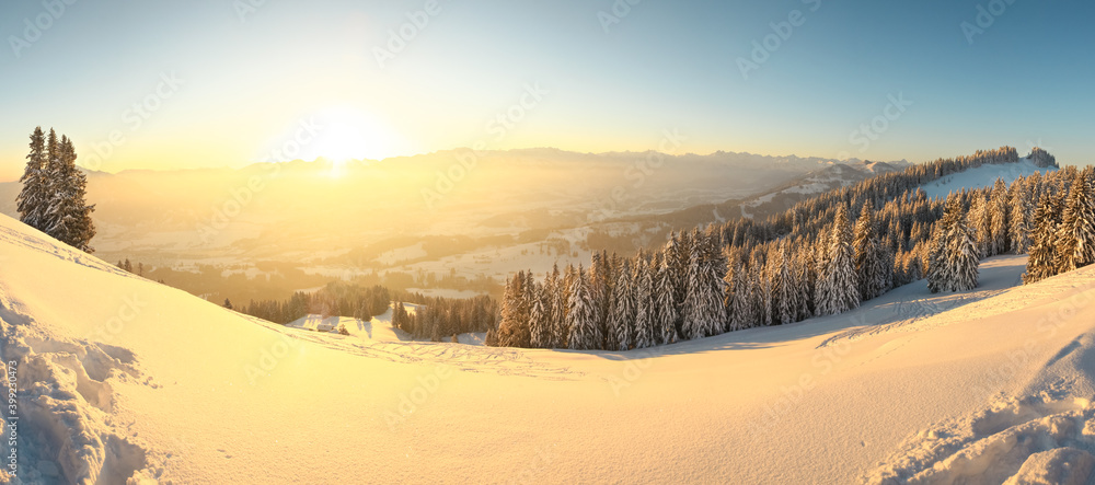 Beautiful Sunrise in snow mountains landscape. Amazing yellow Sunshine. Allgau, Mittag Mountain, Bavaria, Alps, Germany.