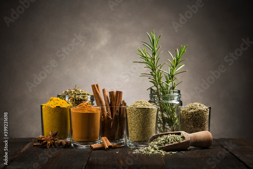 Fototapeta Naklejka Na Ścianę i Meble -  glass jars with various spices on wooden table