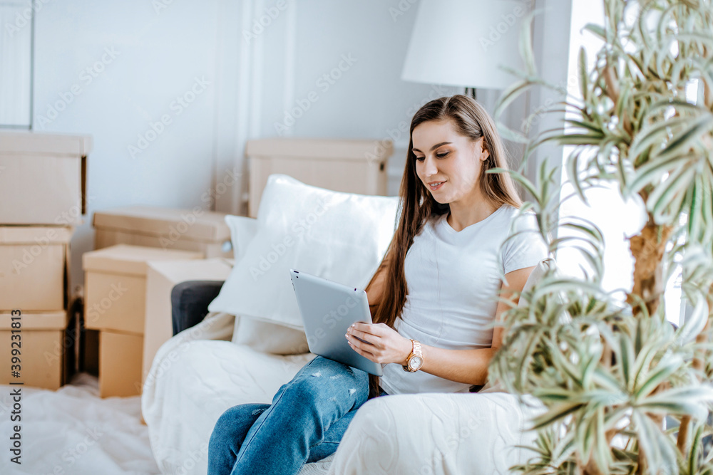young woman with digital tablet sitting on a comfortable sofa young woman with digital tablet sitting on a comfortable sofa