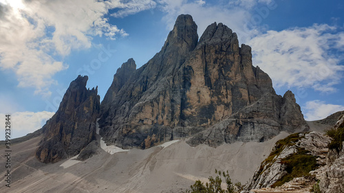 A close up view on Italian Dolomites. There are many high and sharp peak in front, with many landslides. Dangerous climbing. Barely any plants growing in the area. Raw and unspoiled landscape